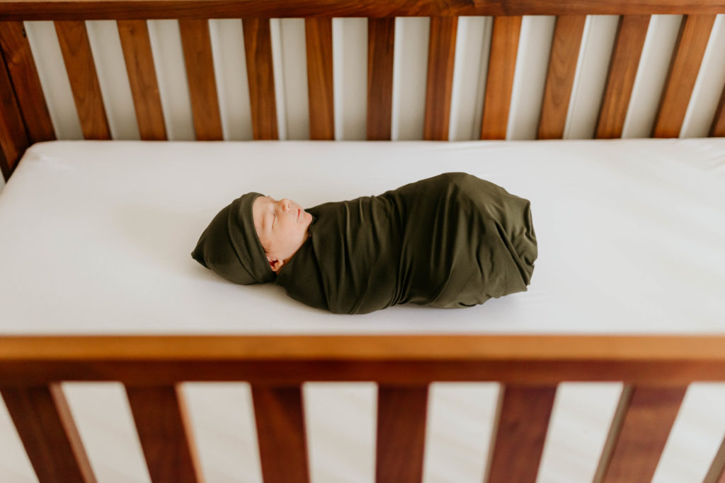 baby in crib In Home Newborn Photography