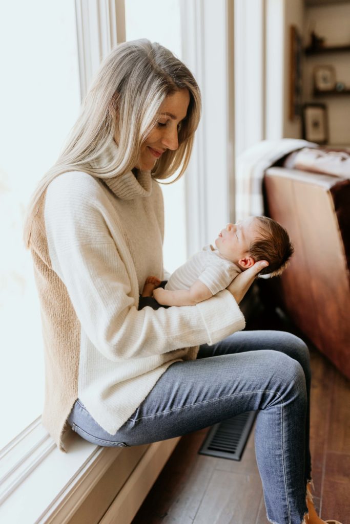 Mom holding baby In Home Newborn Photography