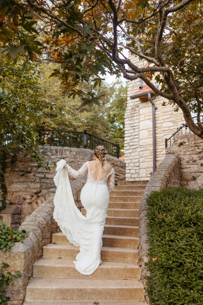bride on stairs at The Inns at St. Albans