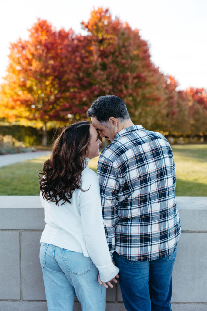 St. Louis wedding photographer with engaged couple in fall Forest Park