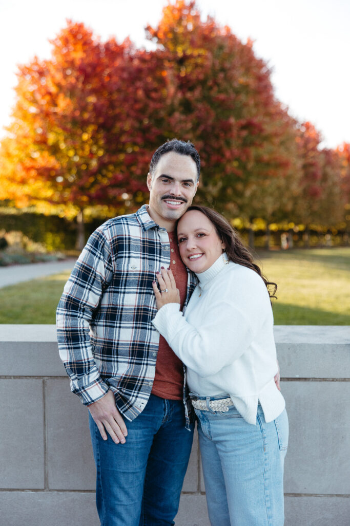 St. Louis wedding photographer with engaged couple in fall Forest Park
