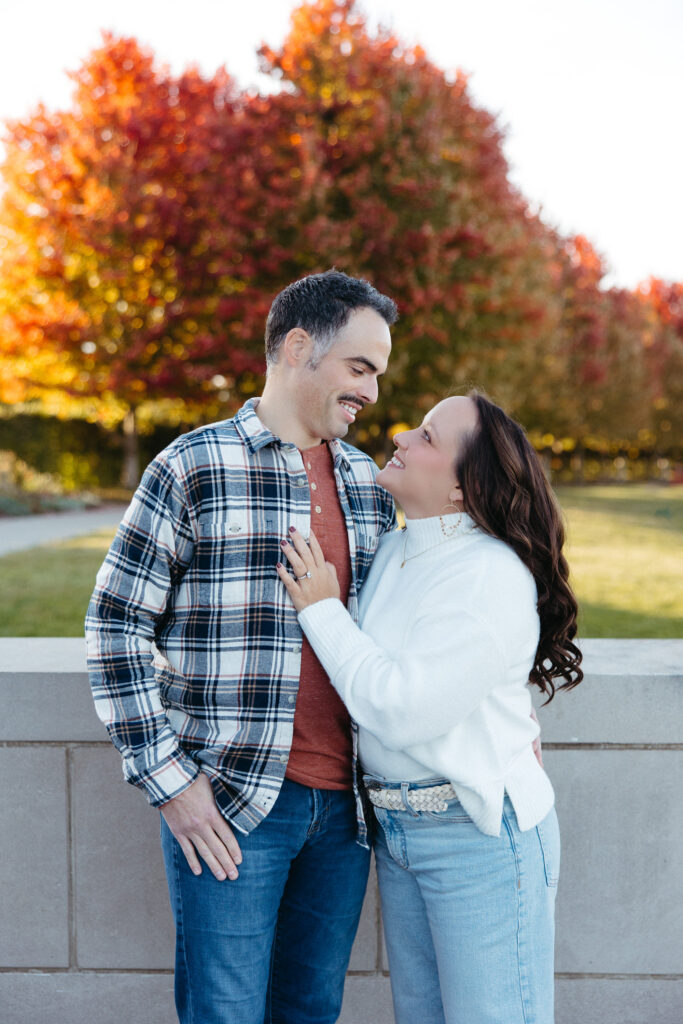 St. Louis wedding photographer with engaged couple in fall Forest Park