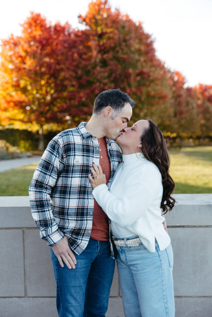 St. Louis wedding photographer with engaged couple in fall Forest Park