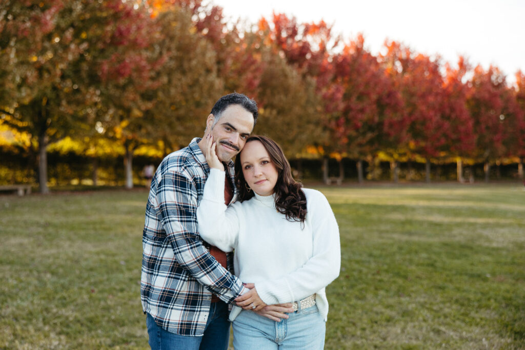 St. Louis wedding photographer with engaged couple in fall Forest Park