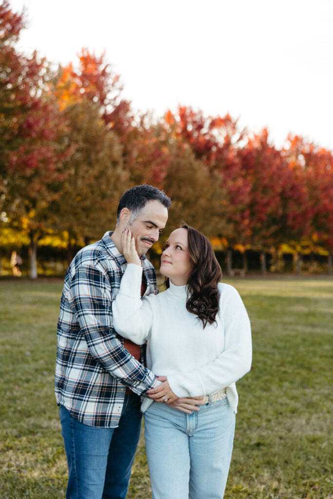St. Louis wedding photographer with engaged couple in fall Forest Park