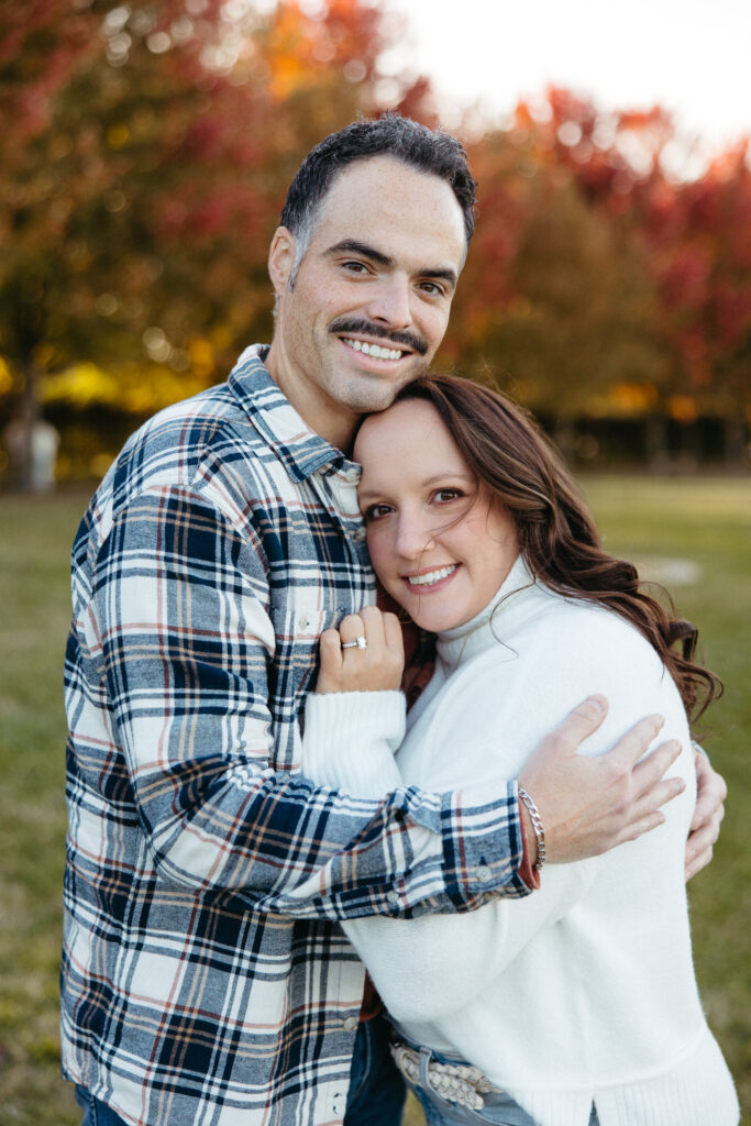 St. Louis wedding photographer with engaged couple in fall Forest Park
