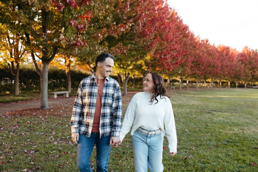 St. Louis wedding photographer with engaged couple in fall Forest Park