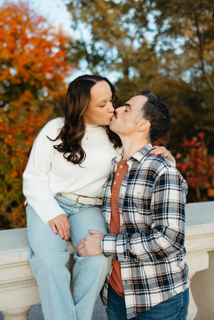 St. Louis wedding photographer with engaged couple in fall Forest Park