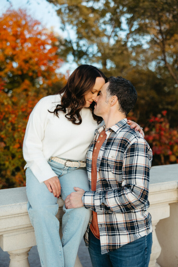 St. Louis wedding photographer with engaged couple in fall Forest Park