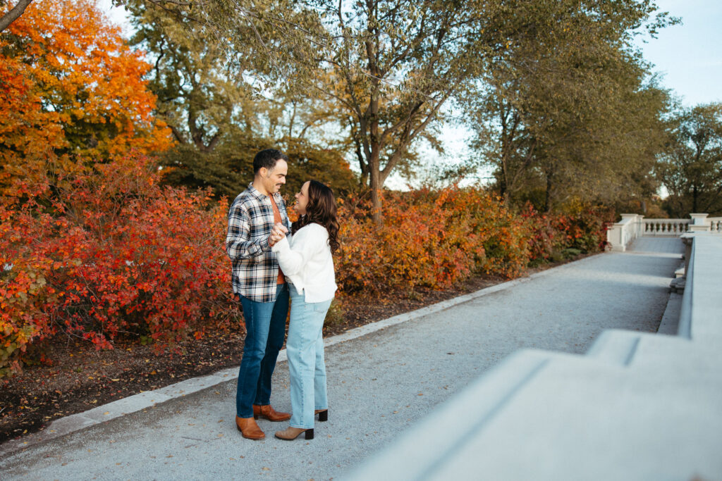 St. Louis wedding photographer with engaged couple in fall Forest Park