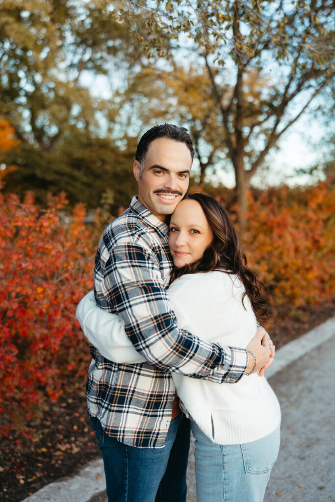St. Louis wedding photographer with engaged couple in fall Forest Park